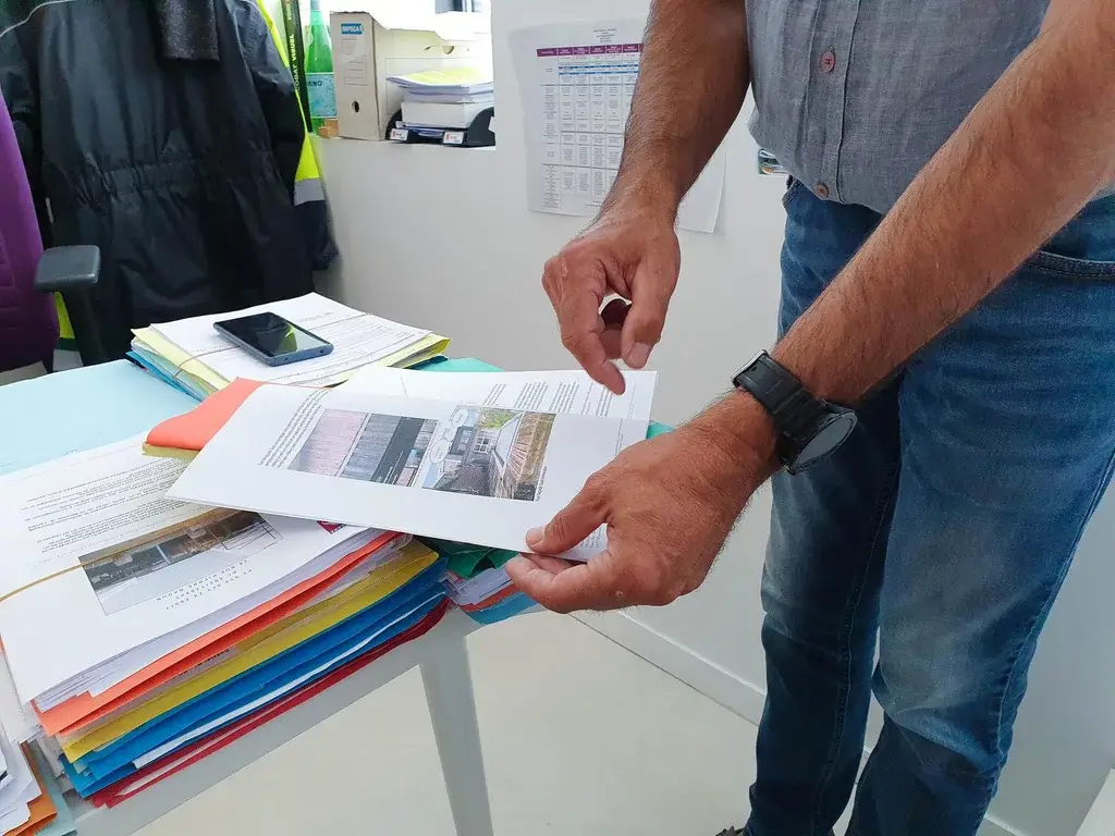 A man going through a planning document in an office