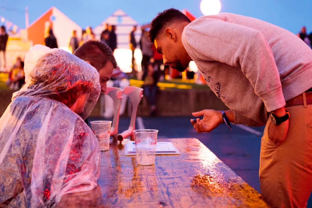 A team member chatting with festival-goers at the Francofolies in La Rochelle