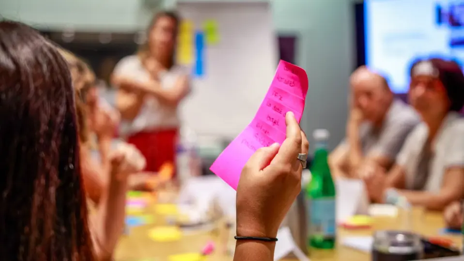 A woman reading her ideas on the sticky notes