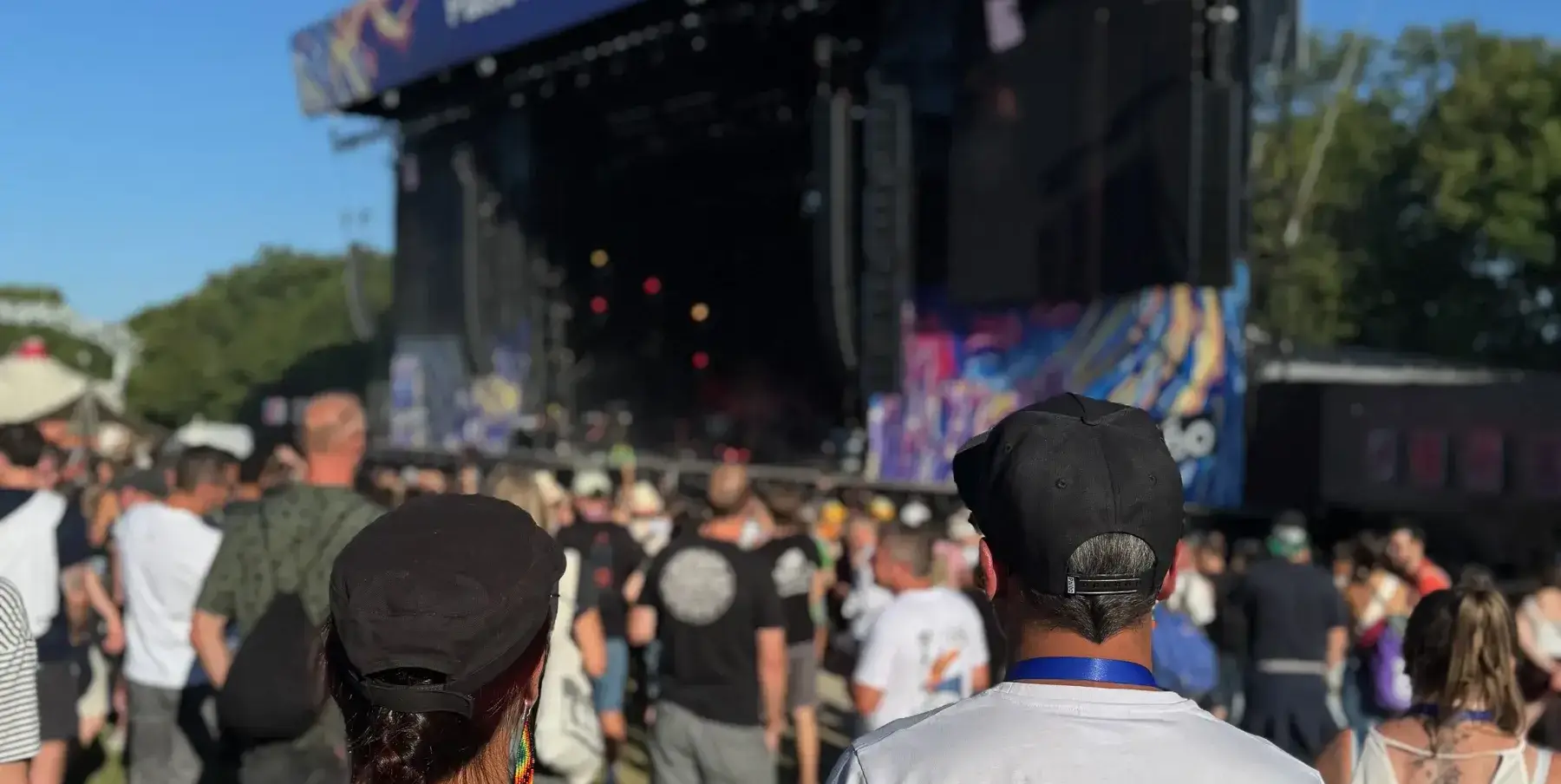 Staff volunteer seen from behind, facing the illuminated main stage