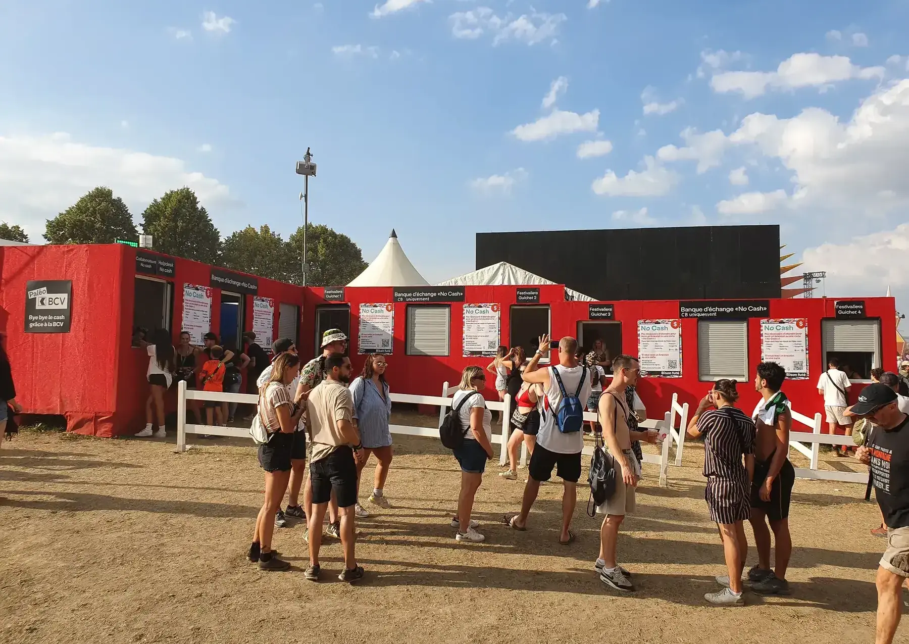 Paléo's red welcome tent with festival-goers at the entrance