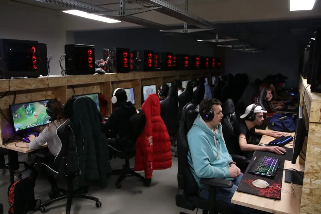 Several players in their chairs in front of their PCs