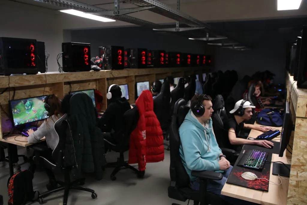 Several players in their chairs in front of their PCs