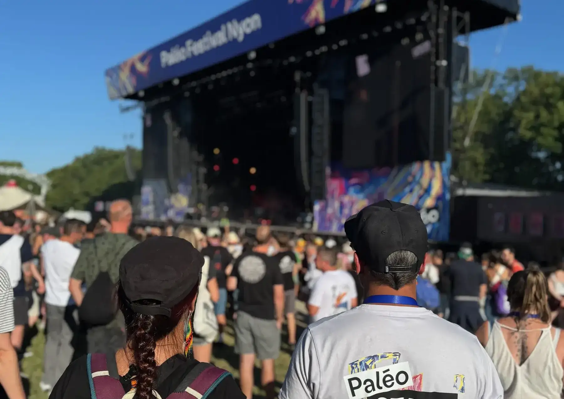 Staff volunteer seen from behind, facing the illuminated main stage