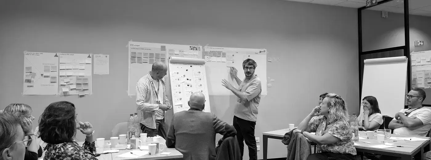 Strategic mapping seminar with participants gathered around workshop material