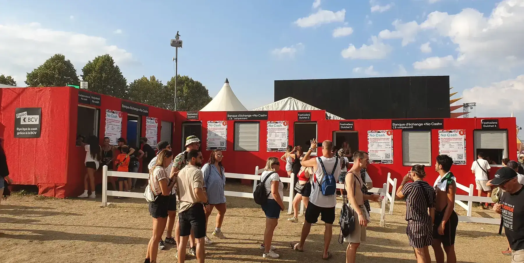 Paléo's red welcome tent with festival-goers at the entrance