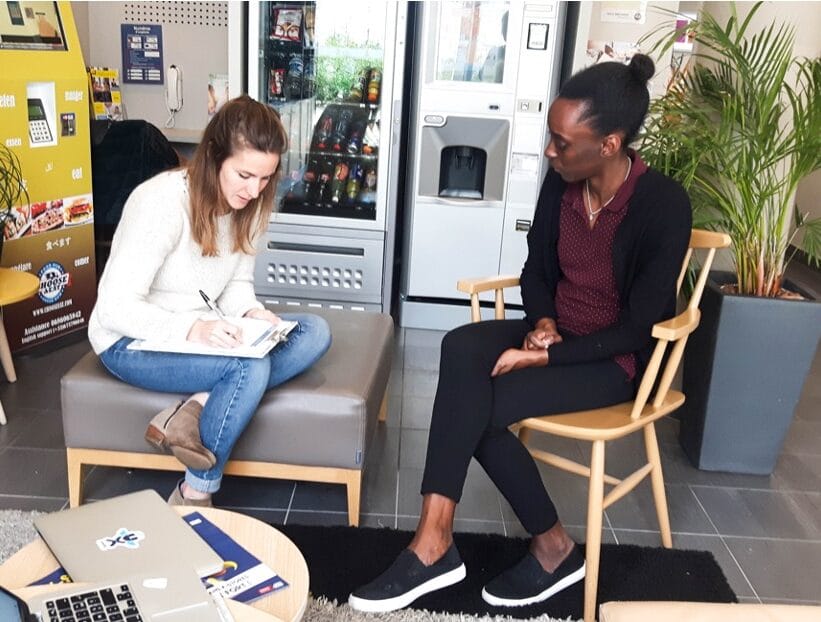 Charlotte rencontre une cliente dans l'entrée d'un hôtel B&B